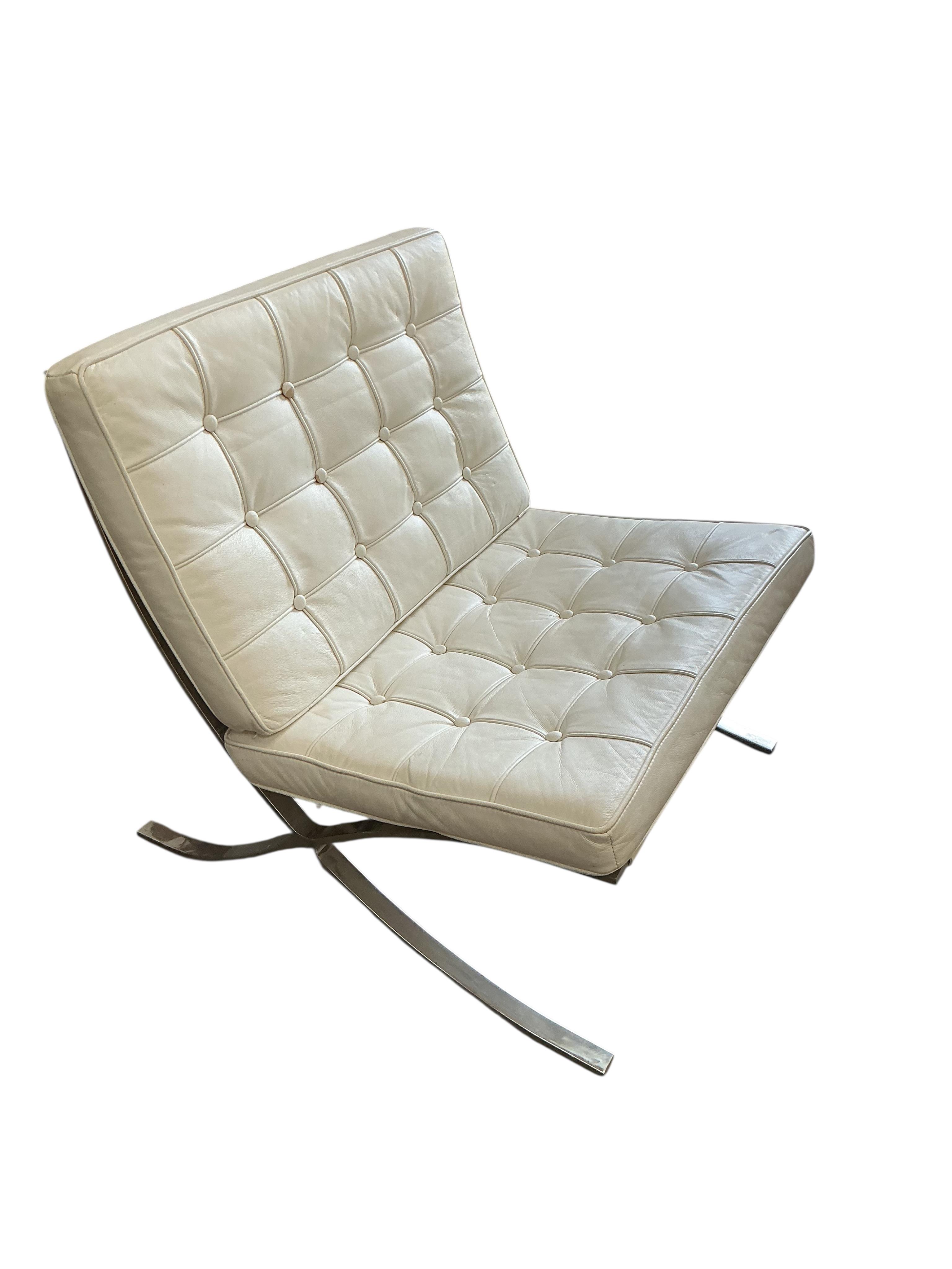 A 'Barcelona style' white leather chair, width 76cm, depth 70cm, height 74cm together with a footstool